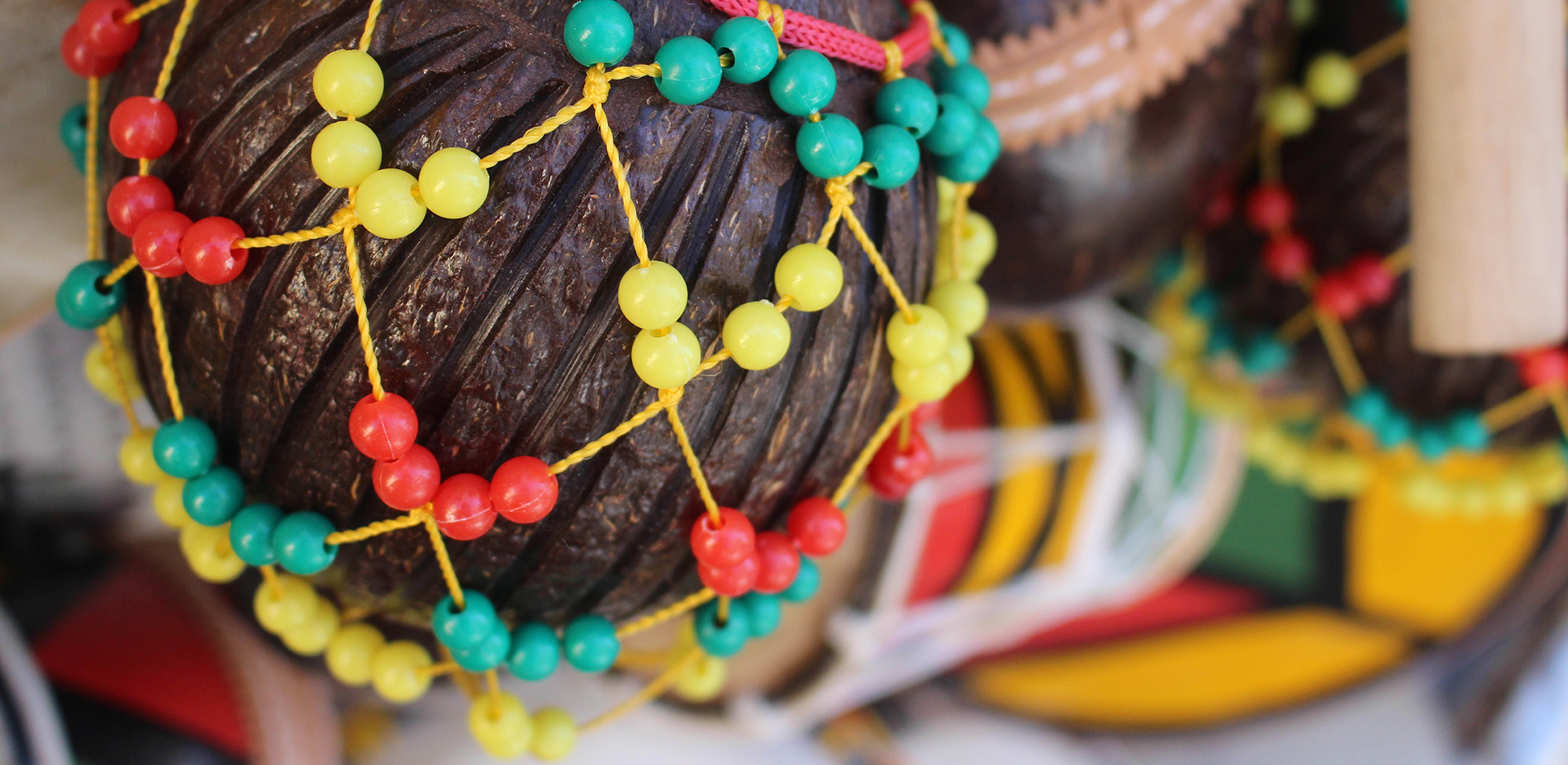 Decorative ornament covered in yellow, green, and red beads
