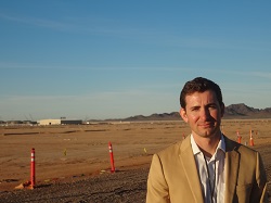 Chester Klotz standing in a large field