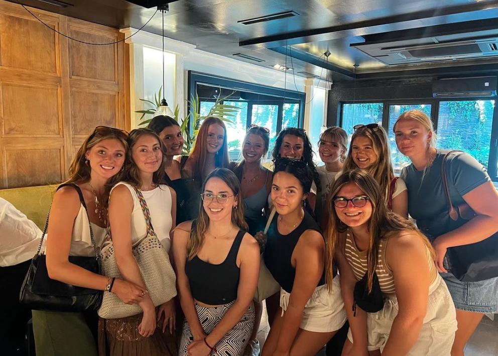 Group photo of students posing at a restaurant