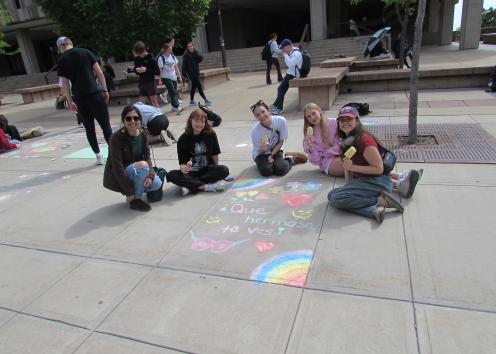 Students sitting near chalk art